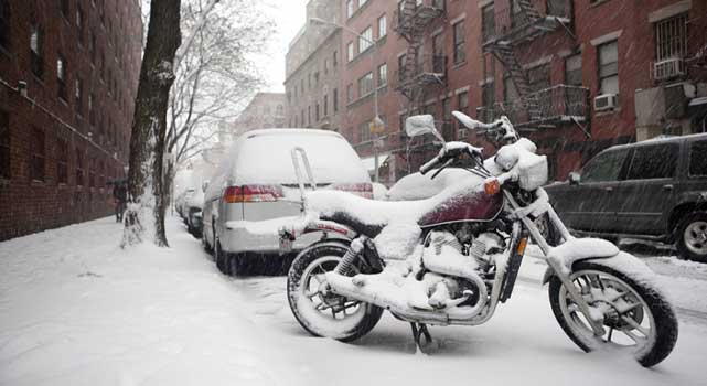 Unprotected motorcycle left out in the snow. That'll really up the resale value.